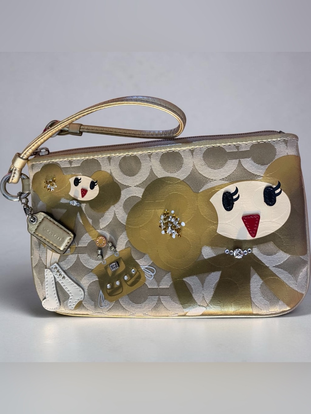 Coach, Poppy Chan golden signature OP art wristlet